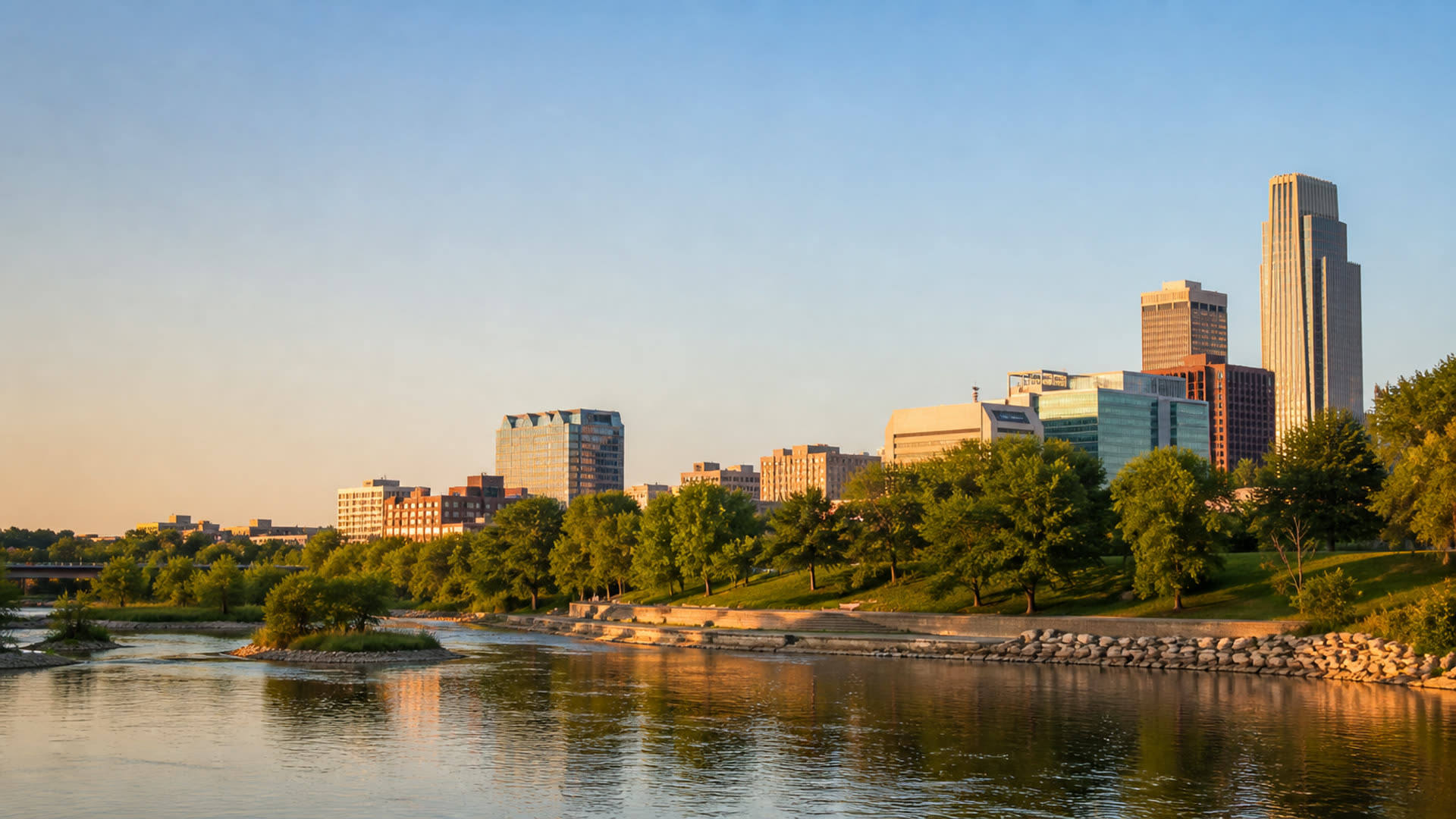 Downtown Omaha skyline above the river at sunset